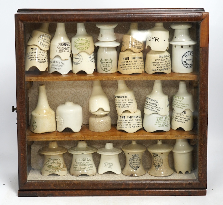Approximately fifty assorted Victorian pottery pie funnels, some contained within a mahogany display case. Condition - varies